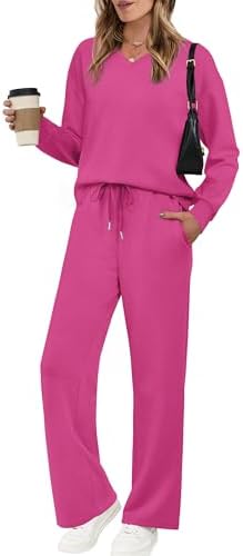 A soft pink two-piece lounge set pairs a dropped-shoulder V-neck top with wide leg pants for easy travel days and relaxed mornings.
