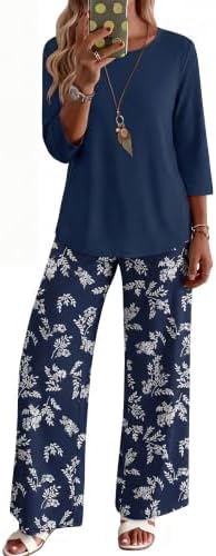 Crisp white florals over deep navy blue define this coordinated two-piece knit set with three-quarter sleeves and side pockets.