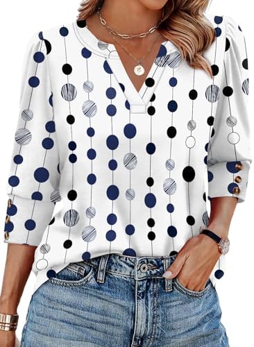 Crisp white dots on deep navy ground this lightweight three-quarter sleeve blouse cut with button cuffs and an open V-neckline.