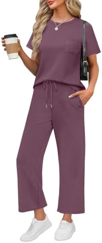 A spacer knit two piece set in rich dark purple, combining a short sleeve crew top with wide cropped pants for easy packing.