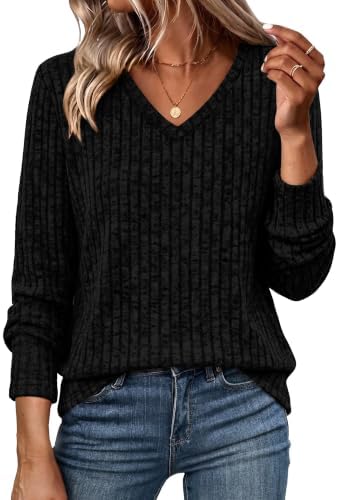Ribbed black knit brings clean lines and easy stretch to a relaxed tunic cut that falls past the hips.