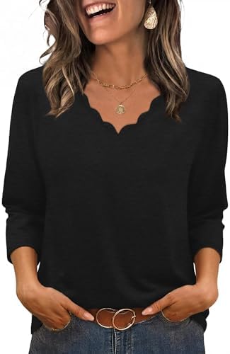 A softly scalloped neckline and three-quarter sleeves give this breathable black tunic top an easy, polished silhouette.