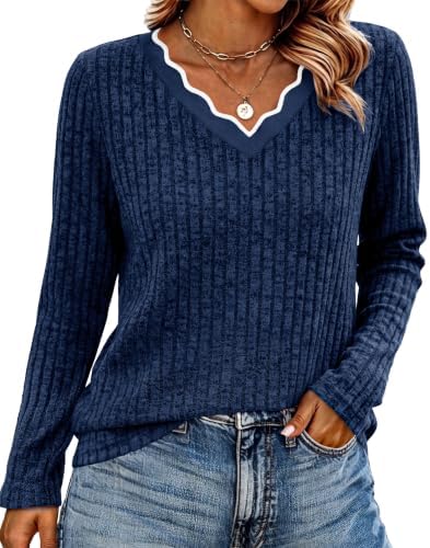A soft blue knit sweater cut with an eye-catching scalloped neckline and an easy, relaxed drape through the body.