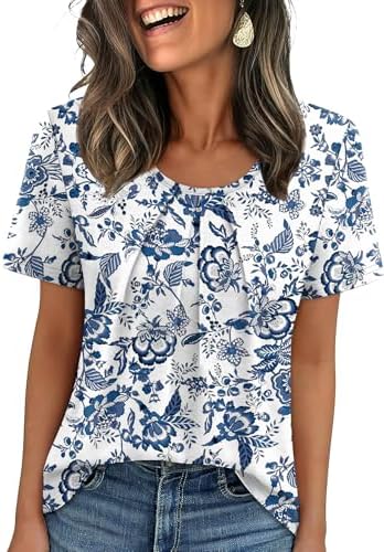 Tiny blue florals scatter across a loose pleated top designed with short sleeves and an open scoop neckline.