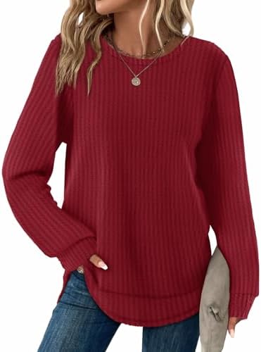 A rich red waffle knit tunic cut with long sleeves and a gentle curved hem for easy layering on cool evenings.
