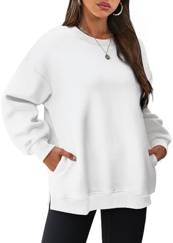 A crisp white fleece pullover with discreet side pockets and subtle hem slits for cool evenings.