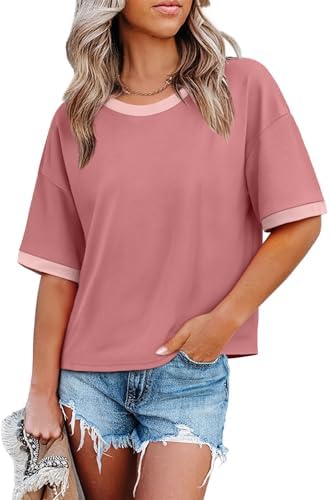 Bright pink knit meets contrast color-block bands at the neckline and hem in a breezy, loose half-sleeve cut.