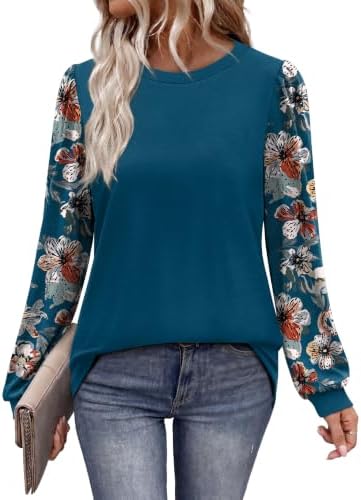 Patterned puff sleeves meet deep teal knit in a loose tunic cut that pairs easily with leggings and dark denim.