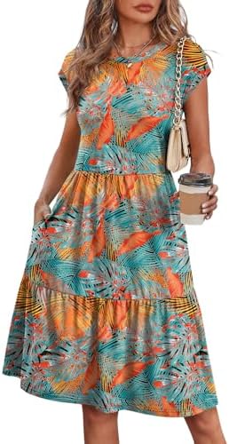 Lush botanicals across soft tiers make this cap-sleeve sundress an easy pick for warm travel days and boardwalk walks.