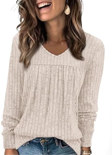 A soft beige knit with vertical ribs and subtle front pleating offers an easy layer for cool mornings and long travel days.