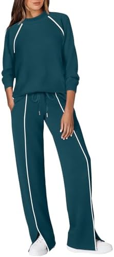 Fine piping outlines this sporty teal knit set, paired with a neat mock neck and practical front pockets.