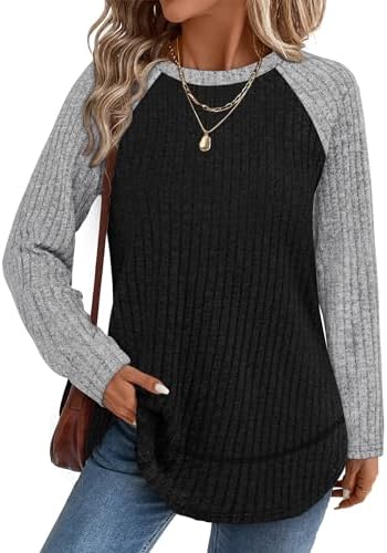 A paneled grey and black tunic knit with a curved high-low hem and side slits for crisp evenings.