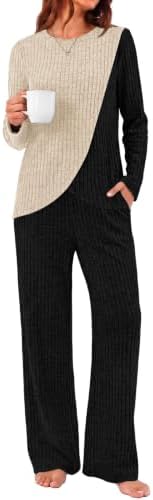 A relaxed beige top with black contrast panels pairs with matching pull-on pants in a soft, stretchy transitional knit.