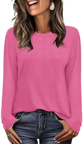 A vivid hot pink knit cut with fine collar pleats, long sleeves, and a generous tunic hem that falls past the hip line.