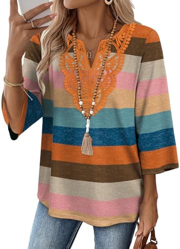 Bold horizontal stripes meet delicate front lace on a soft tunic cut with three-quarter sleeves and a curved hem.