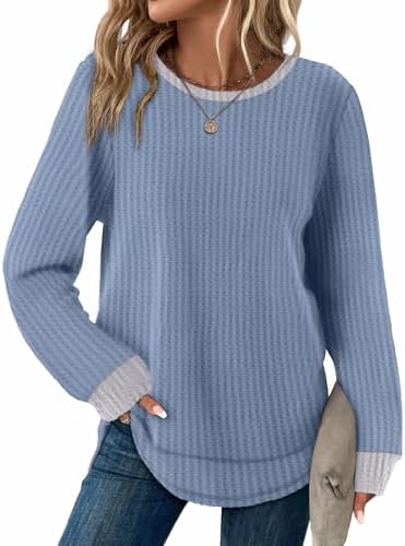 A muted blue-grey waffle knit cut long in the body with a curved hem that sits comfortably over jeans and leggings.