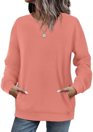 A bright coral knit pullover with dropped shoulders and a hidden side pocket for easy layering on cool evenings.