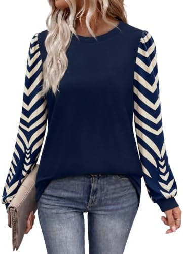A deep dark blue knit body pairs with patterned puff sleeves for an easy tunic that works across the cooler months.