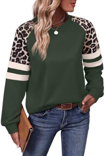 A soft green knit body meets patterned leopard sleeves on this relaxed crewneck tunic cut to fall below the hips.