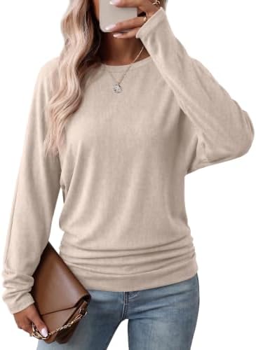 A soft apricot knit with batwing sleeves and gathered side ruching gives this crewneck top a relaxed blouson shape at the hips.