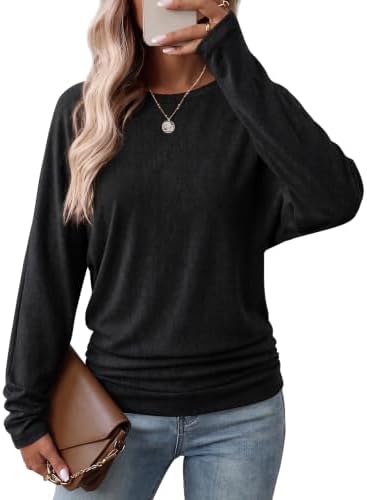 A relaxed black dolman top with side shirring that gathers gently along the hips for cool evenings and work days.