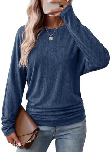 A soft blue knit cut with easy dolman sleeves and side ruching that gathers cleanly at the hips for cool summer evenings.