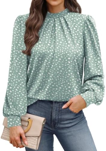 A soft sage green dotted print brings subtle pattern to this mock neck blouse cut with delicate front pleats and puffed sleeves.