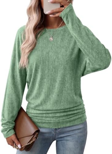 Cut with generous dolman sleeves and ruched side gathers, this vivid bright green tunic pullover brightens up cool-weather routines.