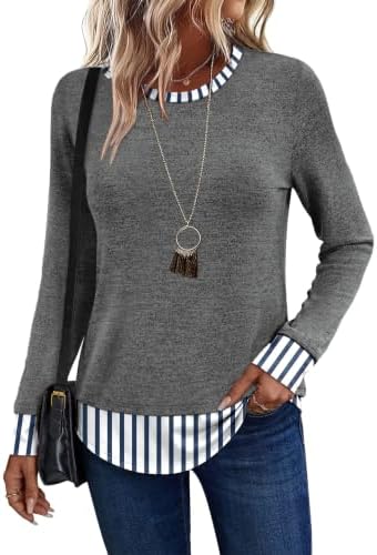 A soft grey body meets a crisp blue striped hem in this lightweight long sleeve tunic cut with extra room through the hips.