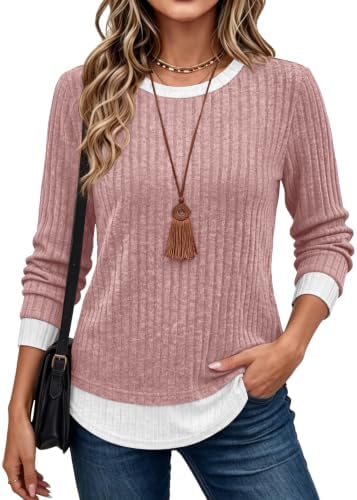 A faux two-piece knit top in soft pink with a contrast round neck and layered hem, cut loose for easy cool-weather dressing.