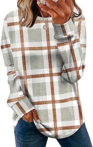 A relaxed tunic sweater cut with a curved hemline and subtle side slits, patterned in an earthy plaid khaki print.