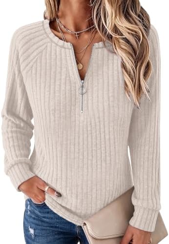 A ribbed knit pullover in warm apricot, finished with an adjustable quarter zip, raglan sleeves, and an easy loose fit.