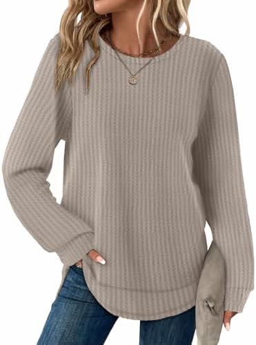 A curved tunic hem and textured waffle knit give this warm khaki pullover an easy drape over dark denim.