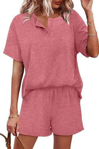 A soft pink two-piece set featuring a short-sleeve henley top paired with pull-on shorts cut with side pockets.