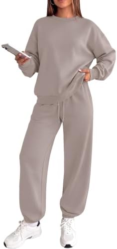 A soft crewneck sweatshirt and relaxed joggers blend muted coffee grey tones with subtle pink for easy travel days.