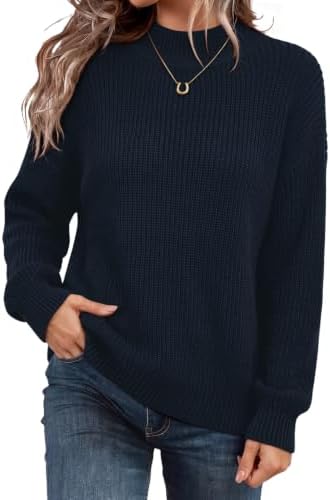 A fuzzy navy knit top cut with a loose mock neck for chilly mornings, breezy travel days, and cool coastal evenings.