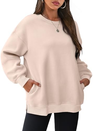A soft apricot fleece pullover cut loose through the body with subtle side slits and hidden pockets.