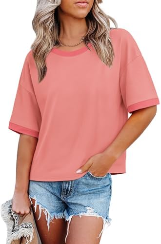 A relaxed coral crewneck tee cut with dropped shoulders, roomier half sleeves, and contrasting color-block trim along the edges.