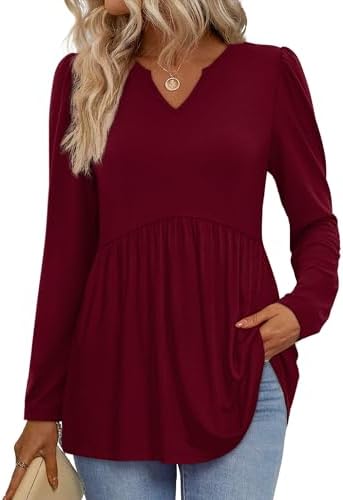 A deep burgundy babydoll top cut with full long sleeves and a gathered waist that leaves plenty of room through the torso.