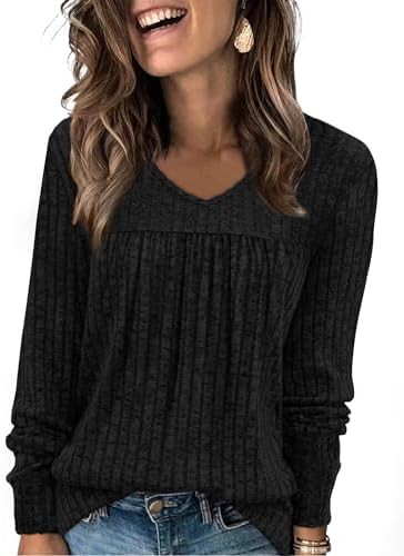 A deep black knit with gentle front pleats and a fine vertical rib gives this long sleeve top a clean drape from morning to night.