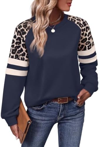 Leopard print sleeves meet deep navy blue in this lightweight crewneck tunic cut with generous hip coverage.
