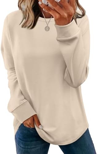 A relaxed tunic sweatshirt in warm khaki, shaped with a rounded hem and subtle side slits for easy layering over leggings.