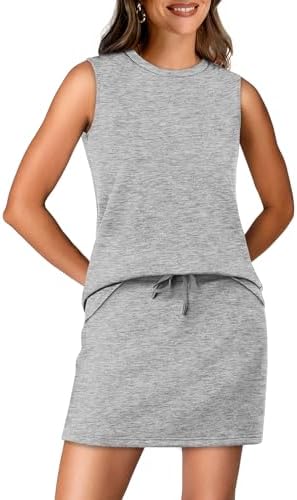 Cool light grey knit shapes this two-piece set featuring a crewneck top and a pleated tennis skirt with hidden pockets.