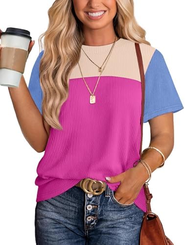 A vivid hot pink knit tunic shaped with an easy crew neck, short sleeves, and a generous hem that pairs cleanly with denim.