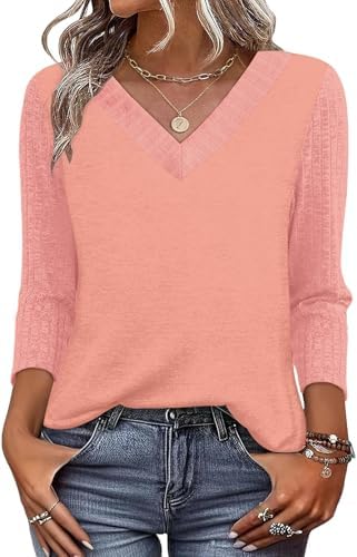 A vivid coral knit top with a classic V-neckline and three-quarter sleeves cut for warm sunny days and travel packing.