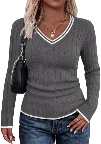 A soft grey cable knit framed by crisp white tipping at the neck, cuffs, and hem for cool mornings and transitional layering.
