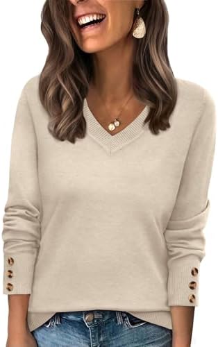 A relaxed beige pullover knit with a wide V-neck collar and three decorative buttons neatly spaced along each sleeve cuff.