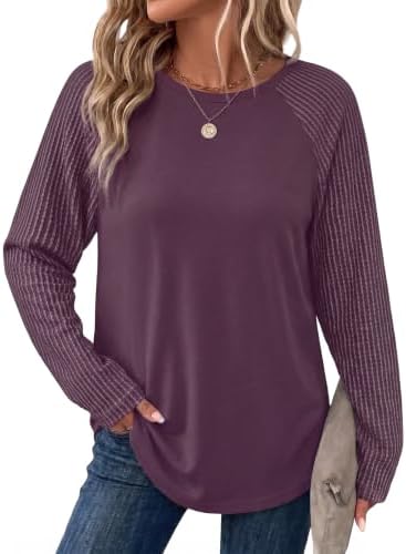 A rich purple tunic knit cut with textured raglan sleeves and a relaxed body that falls smoothly past the hips.