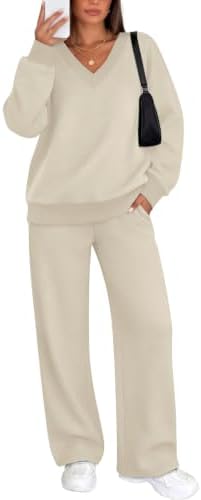 A relaxed two-piece set in pale apricot knit, pairing a ribbed V-neck top with wide-leg pants for easy travel days.