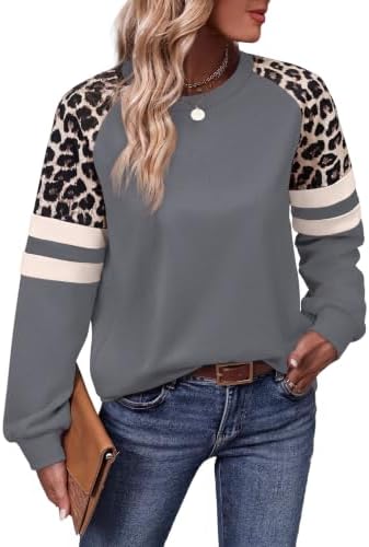 Soft grey knit meets patterned leopard sleeves on a crewneck pullover cut long enough to pull over leggings on brisk mornings.
